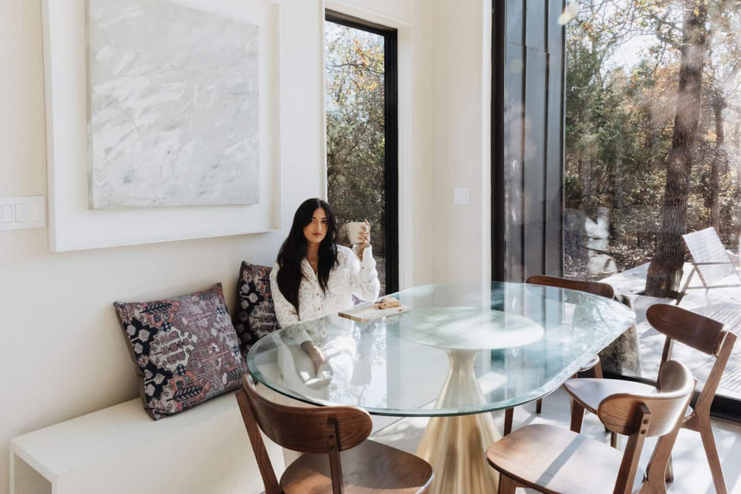 Sunlit dining nook with glass table